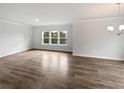 Spacious living room with hardwood floors, crown molding, recessed lighting, and large windows at 2976 Rambler Dr, Loganville, GA 30052
