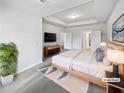 Relaxing main bedroom boasts a tray ceiling, plush carpet, and an inviting ensuite bathroom at 2976 Rambler Dr, Loganville, GA 30052