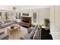 Bright living room with a brick fireplace, hardwood floors, and a sunroom offering ample natural light and cozy comfort at 7040 Northgreen Dr, Atlanta, GA 30328