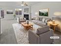 Bright, staged living room featuring a fireplace, large windows, and neutral decor at 7088 Blairs View Dr # 4, Austell, GA 30168