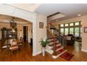 Open foyer with hardwood floors, staircase, and views into the dining and living areas at 2875 Ivy Brook Ln, Buford, GA 30519