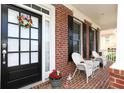 Inviting front porch decorated with a wreath and rocking chairs, perfect for relaxing at 2875 Ivy Brook Ln, Buford, GA 30519