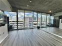 Condo living room with floor to ceiling windows and hardwood floors at 860 Peachtree St # 811, Atlanta, GA 30308