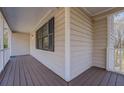 Covered front porch with wood flooring and white railings perfect for relaxing outdoors at 169 Holly Ct, Loganville, GA 30052