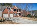 Beautiful brick home featuring a two-car garage, well-kept lawn, and classic architectural details at 672 Red Sunset Cir, Powder Springs, GA 30127