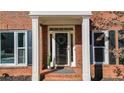 Inviting front entrance with decorative columns and a classic black door at 672 Red Sunset Cir, Powder Springs, GA 30127