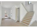Bright hallway featuring stairs with wood treads and an exterior access door at 2369 Drew Valley Ne Rd, Atlanta, GA 30319