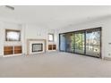 Spacious living room with a fireplace, built-in shelving and sliding glass doors at 2369 Drew Valley Ne Rd, Atlanta, GA 30319