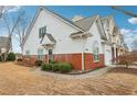 Side view showcasing the brick accents and corner lot landscaping of this lovely property at 2414 Clock Face Ct, Lawrenceville, GA 30043