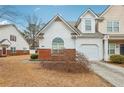 Home with attached garage, manicured bushes, and a driveway leading to the entrance at 2414 Clock Face Ct, Lawrenceville, GA 30043