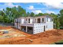 Modern home with wrap under construction, set on a spacious lot with visible framing at 4238 Hamilton Mill Rd, Buford, GA 30519