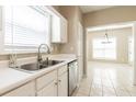 Bright kitchen with stainless steel appliances, white cabinets, and a view into the dining area at 2535 Fairmont Park Ct, Dacula, GA 30019