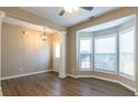 Bright living room featuring hardwood floors, large windows, and elegant architectural columns at 2535 Fairmont Park Ct, Dacula, GA 30019