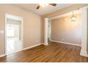 Stylish living area with hardwood floors, decorative columns, and view into a tiled kitchen at 2535 Fairmont Park Ct, Dacula, GA 30019