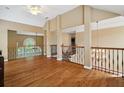 Spacious loft area with hardwood floors, wood railings and natural light at 625 Jefferson Pl, Cumming, GA 30040