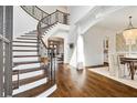 Bright foyer featuring hardwood floors, grand staircase, and elegant chandelier at 1355 Cashiers Way, Roswell, GA 30075