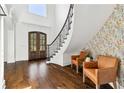 Welcoming foyer with staircase, dark wood floors, and stylish seating area at 1355 Cashiers Way, Roswell, GA 30075