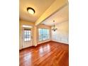 Inviting dining room featuring hardwood floors, wainscoting, and lots of natural light at 3476 Harvest Ridge Ln, Buford, GA 30519