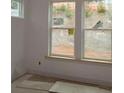 Unfinished bedroom with large window overlooking the backyard at 4435 Beechnut Cir, Cumming, GA 30028