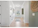 Clean, bright hallway with light wood floors, wainscoting detail, and stylish decor at 224 Silver Leaf Trce, Douglasville, GA 30134