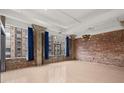 Bright living area features exposed brick, large windows, and concrete columns at 434 Marietta Nw St # 301, Atlanta, GA 30313