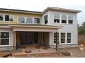 Covered back porch with sliding glass doors, craftsman style columns, and a modern design at 4830 Briscoe Dr, Cumming, GA 30028