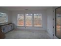 Bright bonus room with unfinished flooring, white trim, gray cabinets, and plenty of natural light at 4830 Briscoe Dr, Cumming, GA 30028