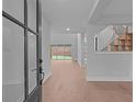 Bright entryway showcasing an open-concept floor plan and hardwood floors throughout the home at 4830 Briscoe Dr, Cumming, GA 30028