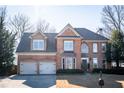 Charming two-story brick home with manicured landscaping, attached two-car garage, and a classic architectural design at 3834 Upland Dr, Marietta, GA 30066