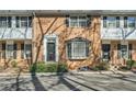 Brick townhomes with classic architectural details like bay windows and black shutters provide a timeless curb appeal at 6520 Roswell Rd # 79, Sandy Springs, GA 30328