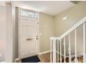 Bright foyer featuring tiled floors, white trim staircase and a white door with decorative glass at 6520 Roswell Rd # 79, Sandy Springs, GA 30328