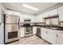 Modern kitchen with white cabinets, stainless steel appliances, and tiled backsplash at 6520 Roswell Rd # 79, Sandy Springs, GA 30328