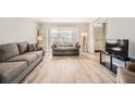Bright living room featuring gray sofas, wood floors, and a large window at 6520 Roswell Rd # 79, Sandy Springs, GA 30328