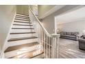 Staircase with hardwood steps, white banister and grey walls leading into the living room at 6520 Roswell Rd # 79, Sandy Springs, GA 30328