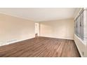 Open living room with wood-look flooring and a large window offering great natural light at 1945 Dodson Sw Dr, Atlanta, GA 30311