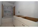 An unfinished bathroom reveals a modern vanity and a partially tiled shower area at 4780 Briscoe Dr, Cumming, GA 30028