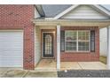 Charming two-story brick home with attached garage and manicured lawn at 4394 Estate St, Atlanta, GA 30349
