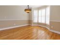 Elegant dining room featuring hardwood floors, chair rail detail, and a decorative chandelier at 76 Misty View Ln, Acworth, GA 30101