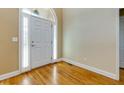 Bright foyer with hardwood floors, complemented by sidelight windows and a white front door at 76 Misty View Ln, Acworth, GA 30101