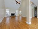 Spacious living room boasts hardwood flooring, a fireplace, and abundant natural light from large windows at 76 Misty View Ln, Acworth, GA 30101
