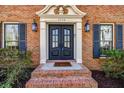 Inviting front entrance with stylish double doors, decorative trim, and brick steps leading to a welcoming home at 3736 Bloxham Ct, Atlanta, GA 30341