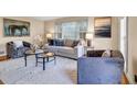 Comfortable living room featuring plush seating, neutral tones, and an abundance of natural light, perfect for relaxation at 3736 Bloxham Ct, Atlanta, GA 30341