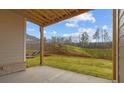View of the yard from the covered patio, showing a retaining wall with steps at 4770 Briscoe Dr, Cumming, GA 30028
