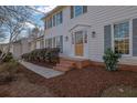 Inviting home entrance featuring a wooden door with glass and well-kept landscaping at 1040 Millridge Se Ln, Marietta, GA 30067