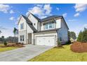 Beautiful exterior of a two-story home featuring a well-maintained lawn, a two car garage and modern design at 4480 Beechnut Cir, Cumming, GA 30028