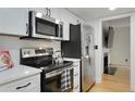 Well-equipped kitchen featuring stainless steel appliances and white cabinets at 29 Ivy Ne Trl, Atlanta, GA 30342