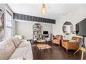 Comfortable living room with stylish furniture, hardwood floors, and an adjacent open office space at 508 Micayne Se Cir, Smyrna, GA 30082