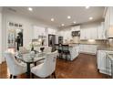 Bright kitchen featuring white cabinets, granite countertops, stainless steel appliances, and hardwood flooring at 3510 Preserve Se Dr, Atlanta, GA 30339
