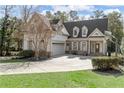 Charming two-story home boasts a side-entry garage and basketball hoop at 4565 Club Ne Dr, Atlanta, GA 30319
