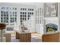 Inviting living room with fireplace, built-ins and lots of natural light from large windows at 4565 Club Ne Dr, Atlanta, GA 30319
